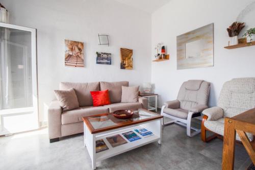 a living room with a couch and a chair at Oceanfront paradise - Mahón in Mahón