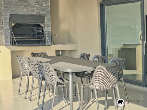 a table and chairs in a kitchen with a counter at 99 on Zwartkloof - Luxury Bushveld Retreat in Warmbaths
