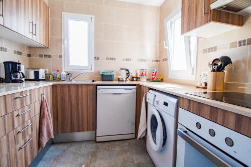 a kitchen with a dishwasher and a washer at Oceanfront paradise - Mahón in Mahón