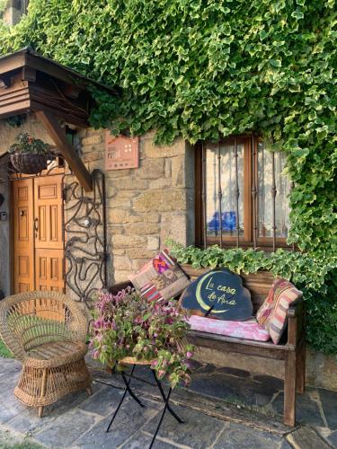 a bench sitting in front of a building with a window at Villa Rural "La casa de ANA" in Muelas de los Caballeros