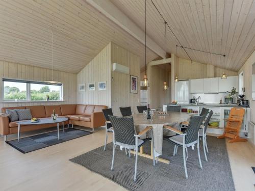 a kitchen and living room with a table and chairs at Holiday Home Iorund - 550m from the sea by Interhome in Haderslev