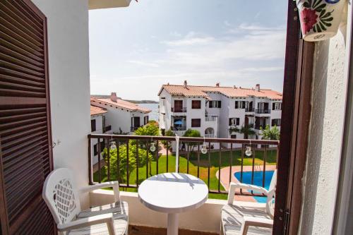 a balcony with a table and chairs and a pool at Oceanfront paradise - Mahón in Mahón