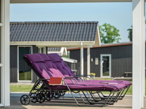 a purple lounge chair sitting on a porch at Holiday Home Iorund - 550m from the sea by Interhome in Haderslev