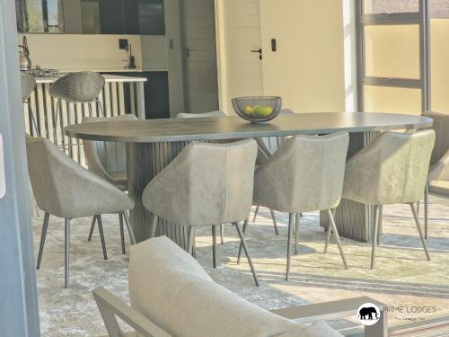 a dining room table with chairs around it at 99 on Zwartkloof - Luxury Bushveld Retreat in Warmbaths
