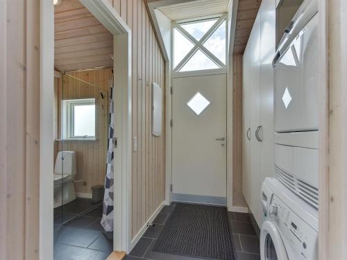 a bathroom with a washing machine and a window at Holiday Home Iorund - 550m from the sea by Interhome in Haderslev