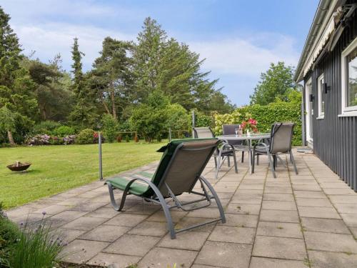 a patio with chairs and a table in a yard at Holiday Home Locan - 1-2km from the sea by Interhome in Humble