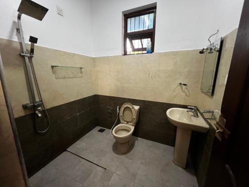 a bathroom with a toilet and a sink at Marian Homestay Negombo in Negombo