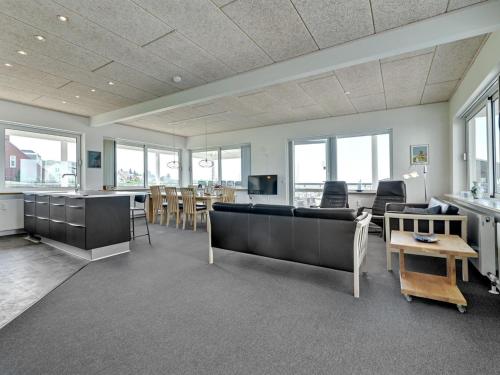 a living room with a couch and a table at Apartment Irma - 25m from the sea by Interhome in Tranekær