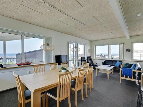 a dining room with a wooden table and chairs at Apartment Irma - 25m from the sea by Interhome in Tranekær