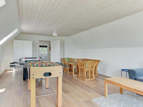 a living room with a table and chairs at Holiday Home Iina - 13km from the sea by Interhome in Bredebro