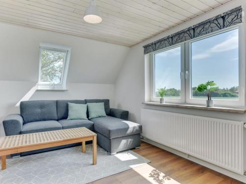 a living room with a couch and a window at Holiday Home Iina - 13km from the sea by Interhome in Bredebro