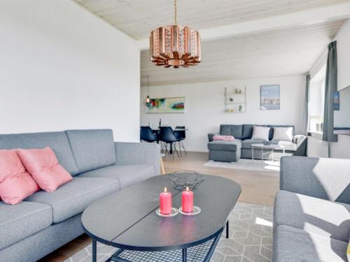 a living room with a couch and a table at Holiday Home Iina - 13km from the sea by Interhome in Bredebro
