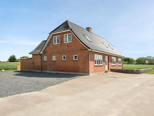 a large red brick building with a roof at Holiday Home Iina - 13km from the sea by Interhome in Bredebro