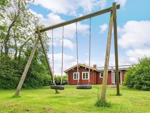 a swing set in front of a house at Holiday Home Ernestine - 500m to the inlet by Interhome in Egernsund