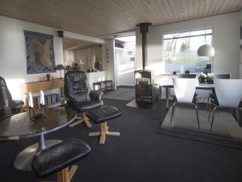 a living room with a table and chairs at Holiday Home Annalie - 50m from the sea by Interhome in Haderslev