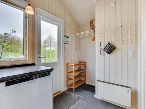 a small kitchen with a window and a counter at Holiday Home Hwiting - 200m from the sea by Interhome in Broager