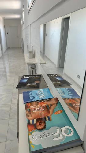 a display in a building with magazines on the floor at Relais Roma Beach in Fregene
