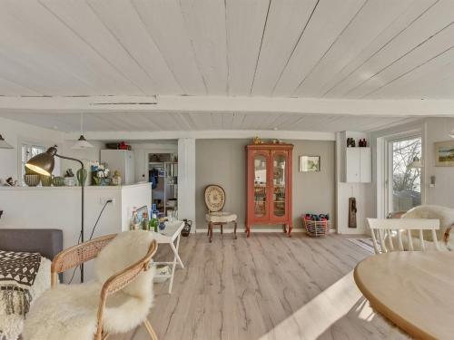 a living room with a table and chairs at Holiday Home Ose - 50m from the sea by Interhome in Sønder Stenderup