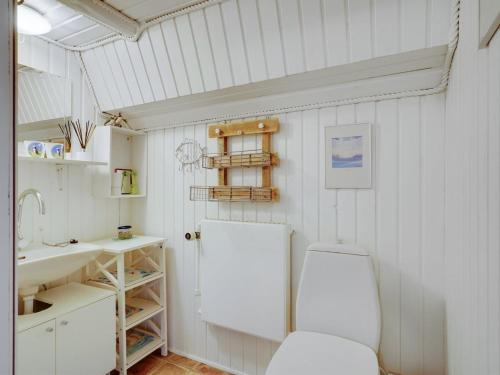 a bathroom with a toilet and a sink at Holiday Home Evje - 250m from the sea by Interhome in Bagenkop
