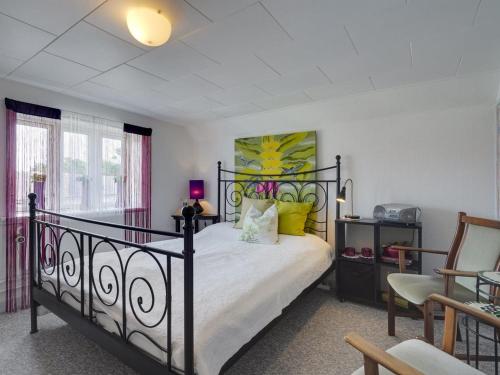 a bedroom with a black bed with yellow pillows at Holiday Home Evje - 250m from the sea by Interhome in Bagenkop