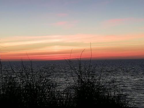 a view of the ocean at sunset at Holiday Home Faina - 100m from the sea by Interhome in Humble