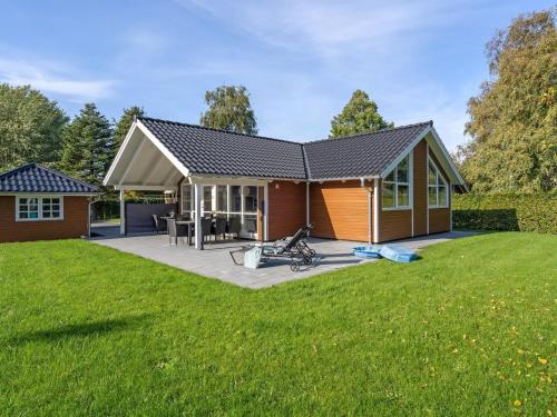 a house with a large lawn in front of it at Holiday Home Hellena - 90m from the sea by Interhome in Skovmose