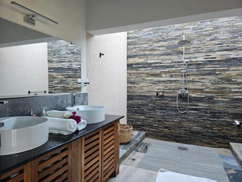 a bathroom with two sinks and a shower at Villa Solenzara - Private Luxury Residence Nosy Be in Nosy Be