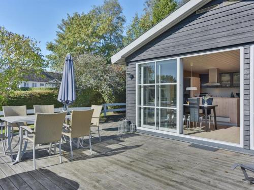 a patio with a table and chairs and an umbrella at Holiday Home Leandra - 600m from the sea by Interhome in Augustenborg