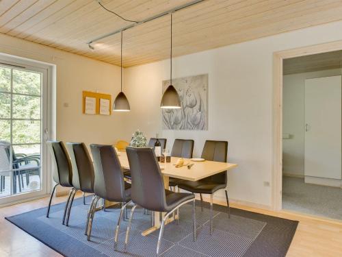 a dining room with a table and chairs at Holiday Home Fausta - 150m to the fjord by Interhome in Gråsten