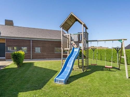a playground with a slide in a yard at Holiday Home Hans - 700m from the sea by Interhome in Neder Lysabild