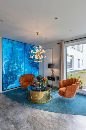 a living room with two chairs and an aquarium at Hotel Nautilus in Putbus