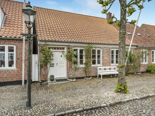 a brick house with a bench in front of it at Holiday Home Ajna - 9-8km from the sea by Interhome in Tønder