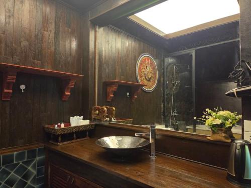 a bathroom with a sink and a mirror at Bantunglom Resort in Mae Rim