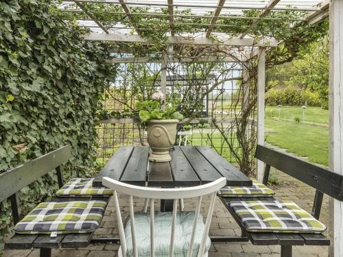 a wooden table with a vase on top of it at Holiday Home Ajna - 9-8km from the sea by Interhome in Tønder