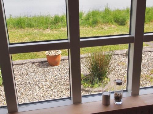 a view from a window of a yard at Holiday Home Udder - 50m to the inlet by Interhome in Aabenraa