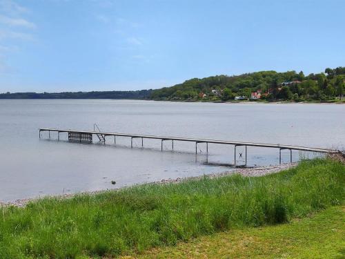 a dock in the middle of a large body of water at Holiday Home Udder - 50m to the inlet by Interhome in Aabenraa