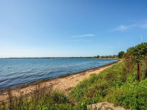 a beach next to the water on a clear day at Holiday Home Palnir - from the sea by Interhome in Egernsund