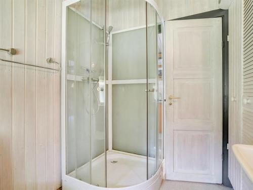 a shower with a glass door in a bathroom at Holiday Home Rentje - 31km from the sea by Interhome in Toftlund