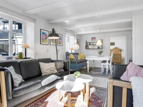 a living room with a couch and a table at Holiday Home Elma - 24km from the sea by Interhome in Højer