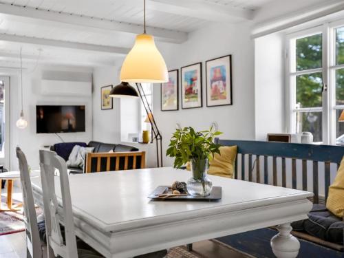 a dining room with a white table and chairs at Holiday Home Elma - 24km from the sea by Interhome in Højer
