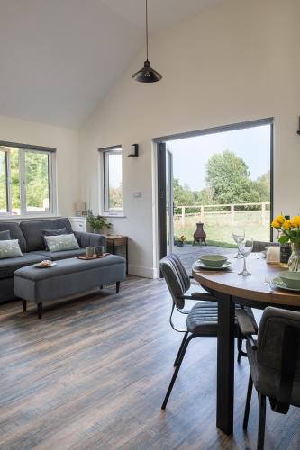 a living room with a couch and a table at Lakeside Lodge in Eastleigh