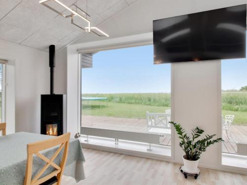 a living room with a large window with a view of a deck at Holiday Home Ajla by Interhome in Bredebro