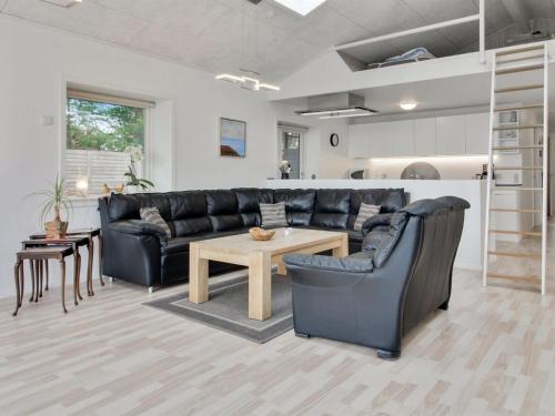 a living room with a couch and a table at Holiday Home Ajla by Interhome in Bredebro