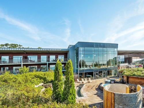 a large glass building with trees in front of it at Holiday Home Skjalm - 100m to the inlet by Interhome in Gråsten