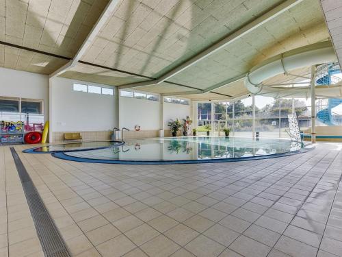 a large swimming pool in a large building with a swimming pool at Holiday Home Skjalm - 100m to the inlet by Interhome in Gråsten