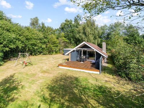a tiny house with a deck and a swing at Holiday Home Pance - 20km to the fjord by Interhome in Toftlund