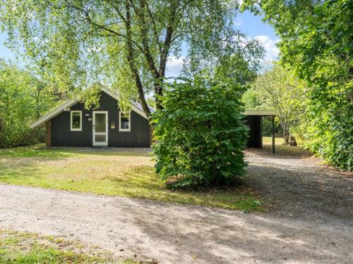 a small house with a tree in front of it at Holiday Home Pance - 20km to the fjord by Interhome in Toftlund
