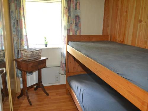 a bedroom with a bunk bed and a window at Holiday Home Florinka - 31km from the sea by Interhome in Toftlund