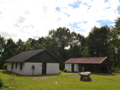 a couple of buildings in a yard with trees at Holiday Home Florinka - 31km from the sea by Interhome in Toftlund