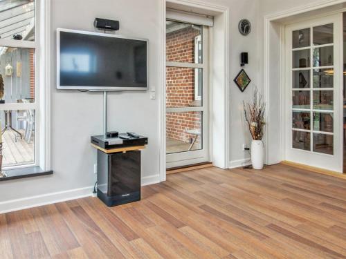 a living room with a flat screen tv on a wall at Holiday Home Birita - 20km from the sea by Interhome in Ribe